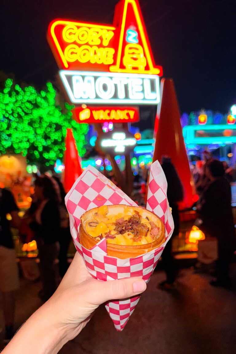 A mac and cheese bread cone in front of the Disney's Cozy Cone Motel.