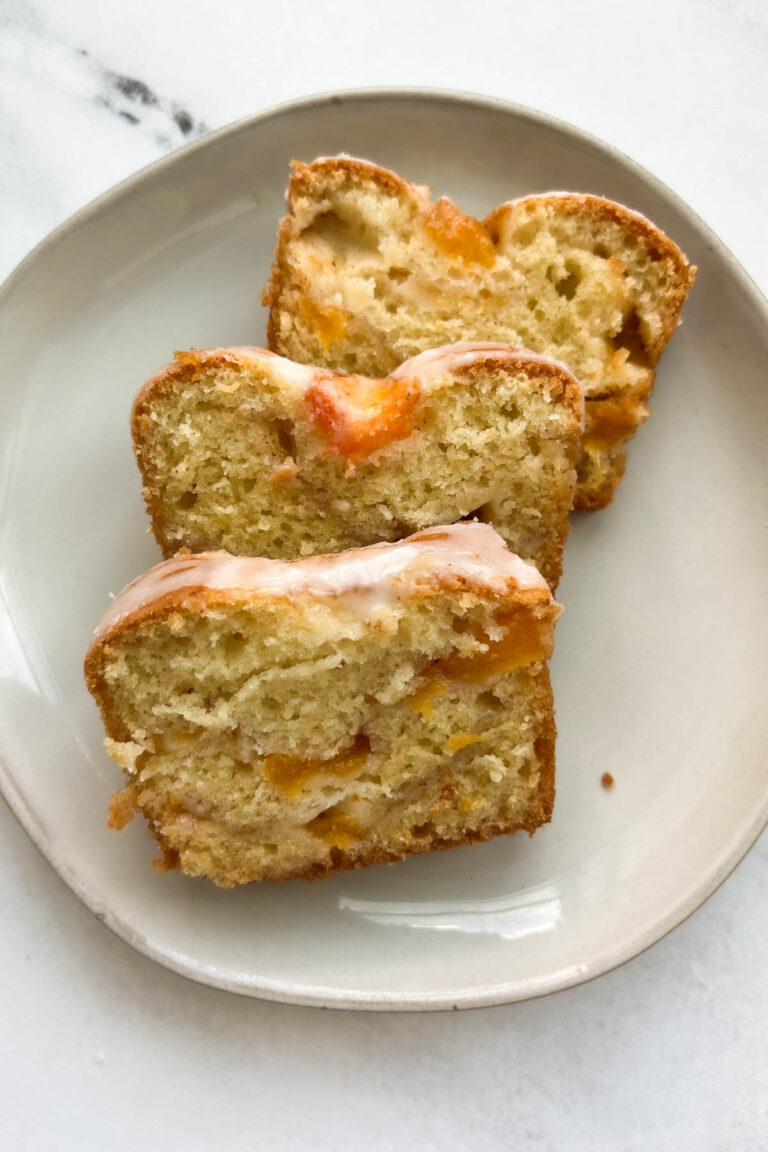 Three slices of peach bread on a white plate.